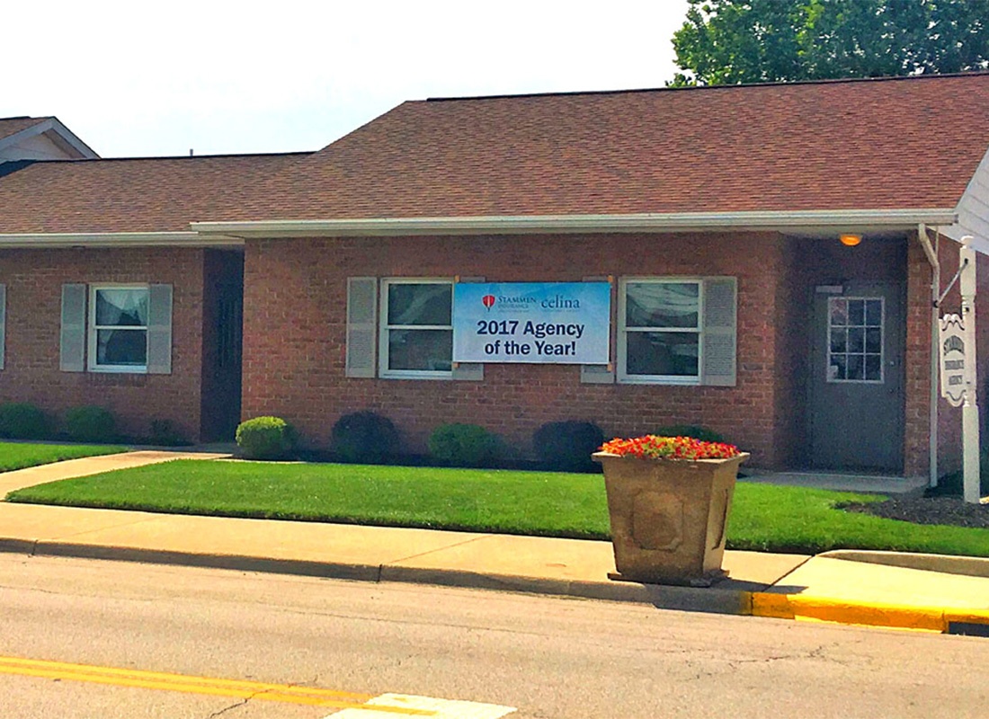 St. Henry, OH - Exterior View of the One Story Brick Building with the Stammen Insurance Office on a Sunny Day in St. Henry Ohio